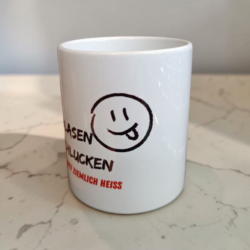 Tasse „Erst blasen, dann schlucken“ – Humor für die Kaffeepause
